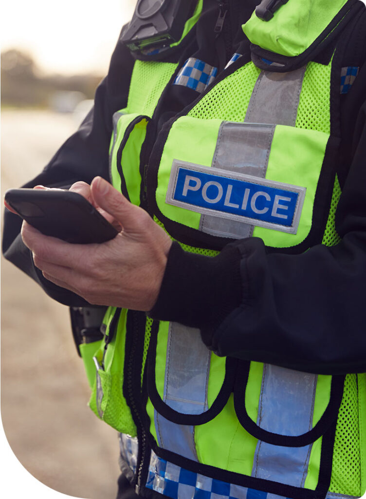 Police officer looking at phone